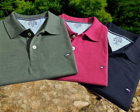 Tommy Hilfiger Matty Polo T-shirts in a pack of 3, featuring solid colors in green, red, and black. Made from premium fabric with a regular fit and polo neck.