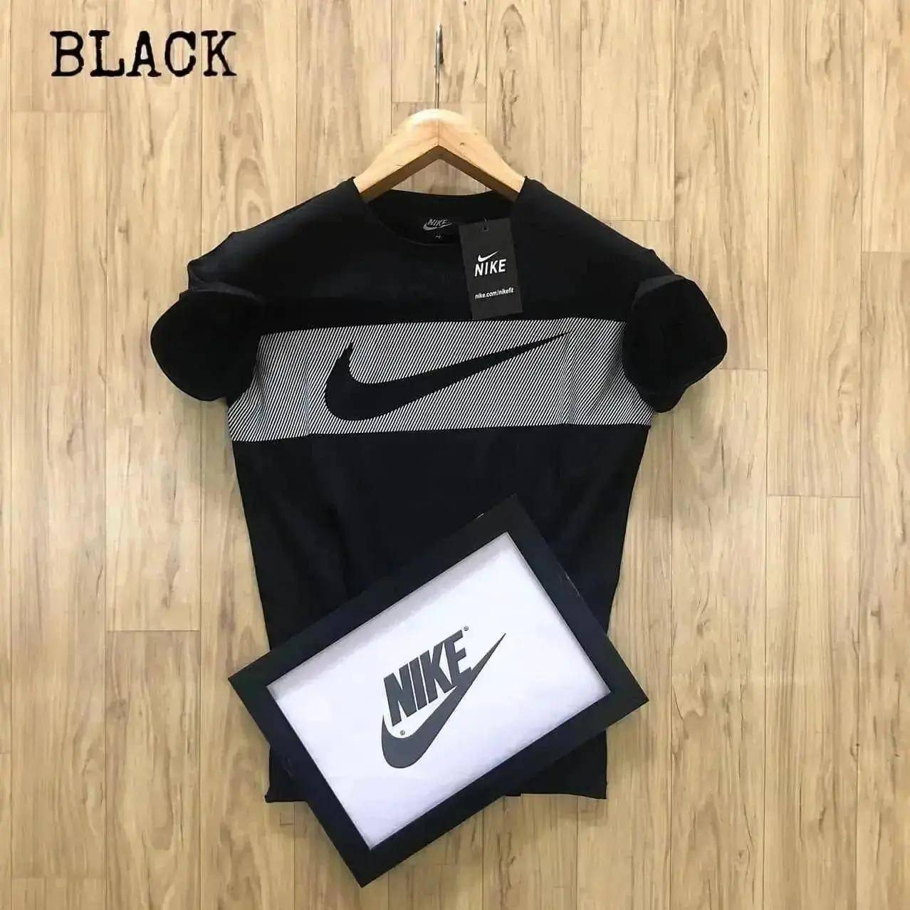 Polyester printed half sleeves men's round neck t-shirt in black with a Nike logo, displayed on a hanger against a wooden background.